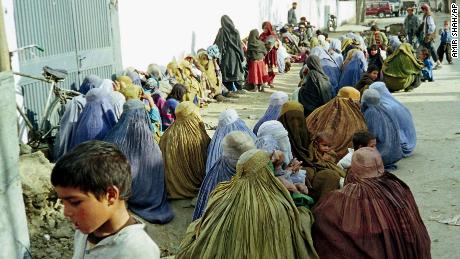 Women huddle outside the UN offices in Kabul seeking help in January, 1999.  
