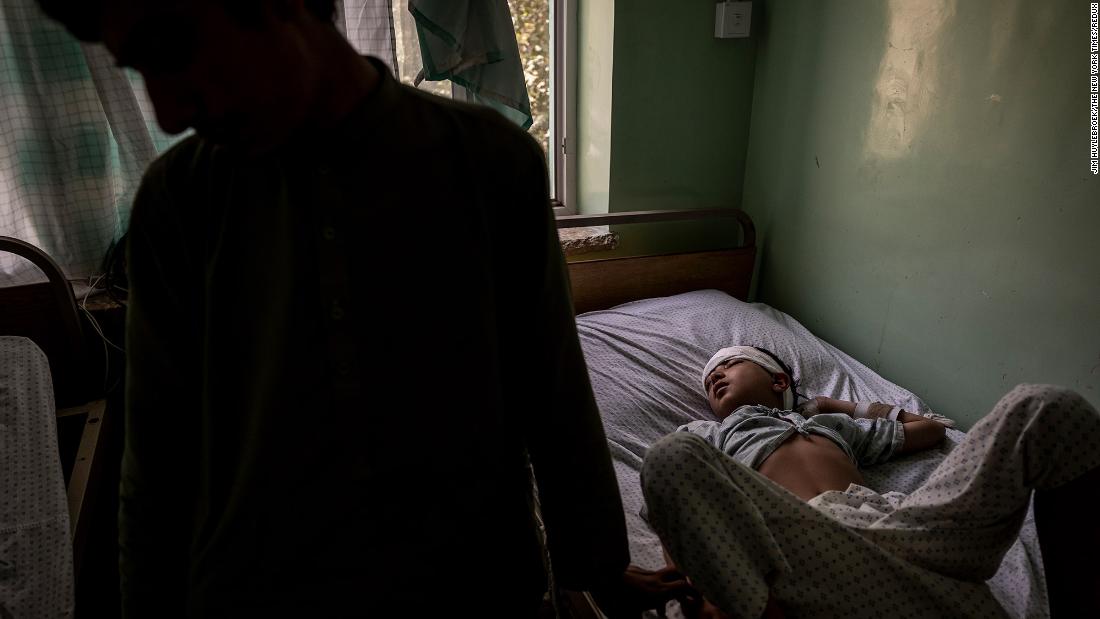 Hanif, who was struck in the temple by a stray bullet, and his older brother, Mohammed, are seen at the Mirwais Regional Hospital in Kandahar in August 2021. Kandahar had been under siege for a month, and it would soon fall to the Taliban.