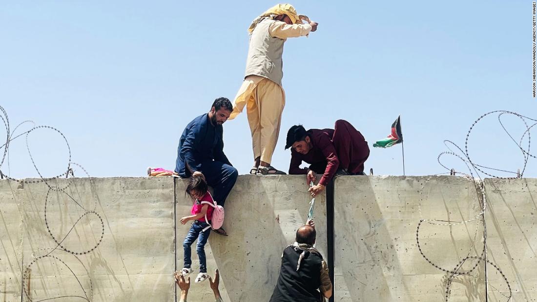 Afghans rush to the airport in Kabul as they try to flee the capital on August 16.