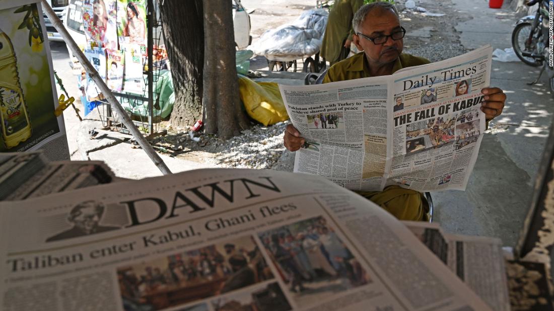 A man in Islamabad, Pakistan, reads news of Kabul's fall on August 16.