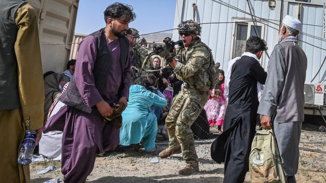 A US soldier points a gun while working to secure Kabul&#39;s airport on August 16. US Defense Secretary Lloyd Austin approved the deployment of 1,000 more American troops into the country due to the deteriorating security situation, a defense official told CNN, upping the number of troops in the country to 6,000. 