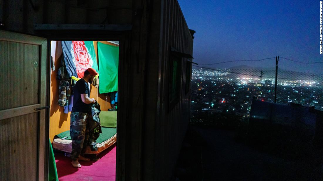 An Afghan soldier, who didn&#39;t want to use his name, is seen at an outpost in Kabul on Sunday, August 15. He looked at the city below and said, &quot;This is like a quick death,&quot; referring to the fall of Kabul. He said it was going to be a hard moment for him when he removes his uniform permanently after 10 years of service.