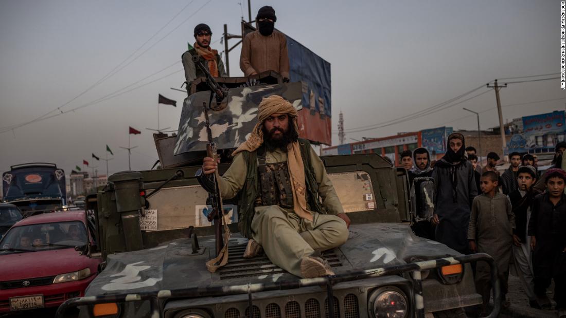 Taliban fighters ride a Humvee near a Kabul roundabout on August 15.