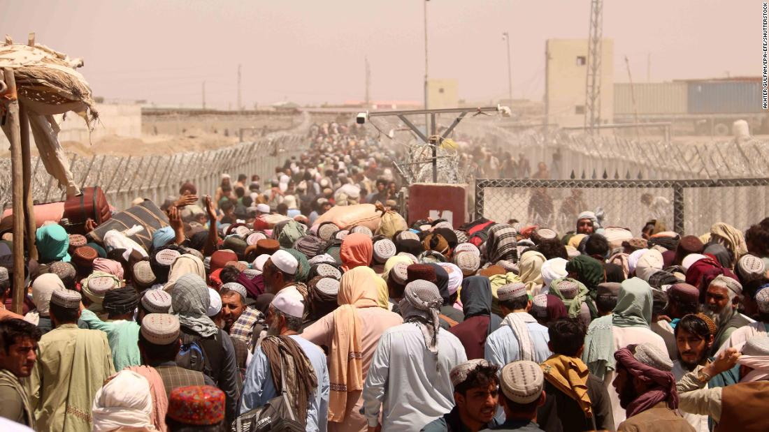 People wait to cross the Afghan-Pakistani border at Chaman, Pakistan, on August 13. The border crossing was closed for several days before it was reopened.