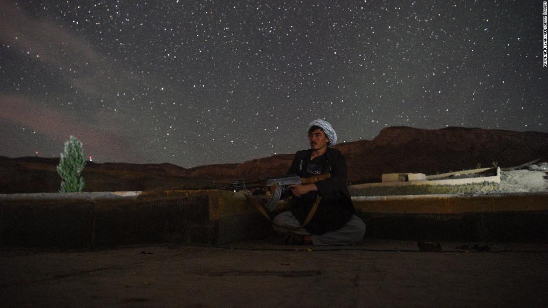 An Afghan militia fighter looks out for Taliban insurgents at an outpost in Afghanistan&#39;s Balkh Province on July 15.