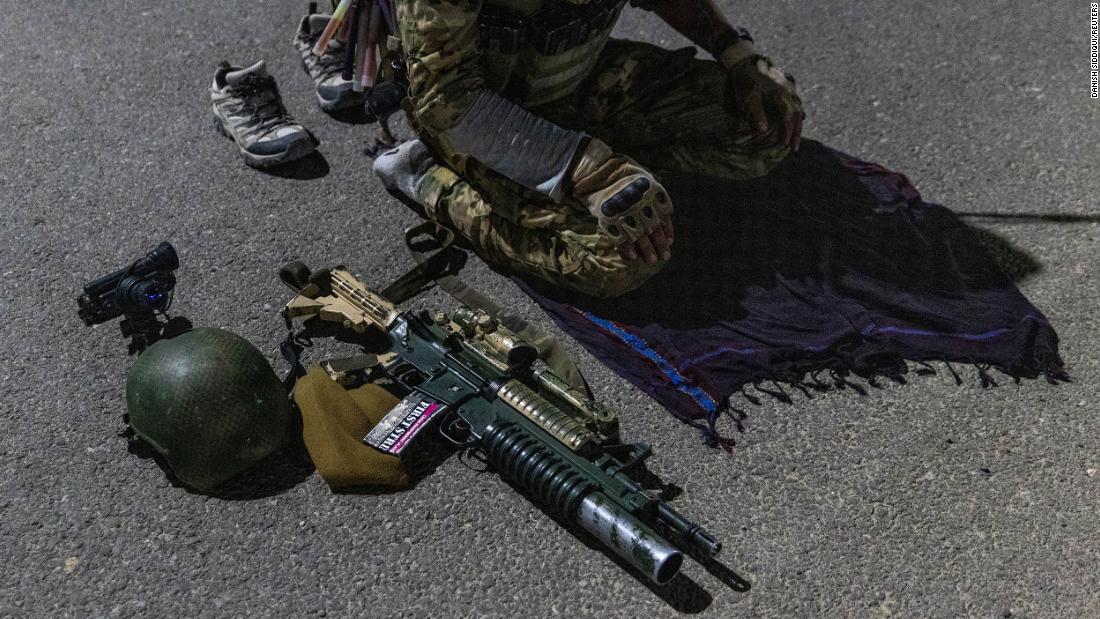 A member of the Afghan Special Forces prays on a highway before a combat mission in Afghanistan&#39;s Kandahar province on July 11.