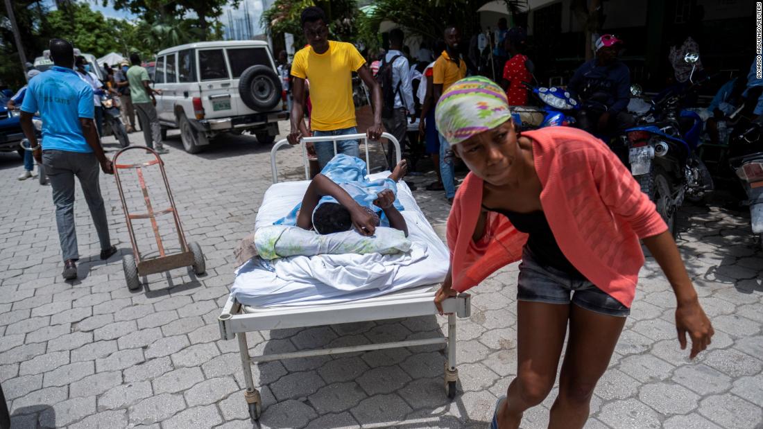 An injured woman is transported to a hospital in Les Cayes on Monday, August 16.