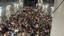 Evacuees crowd the interior of a U.S. Air Force C-17 Globemaster III transport aircraft, carrying some 640 Afghans to Qatar from Kabul, Afghanistan August 15, 2021. Picture taken August 15, 2021.  Courtesy of Defense One/Handout via REUTERS.   NO RESALES. NO ARCHIVES, THIS IMAGE HAS BEEN SUPPLIED BY A THIRD PARTY. MANDATORY CREDIT