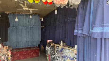 Burqas hang in a market in Kabul on July 31. The price has surged as women rush to cover themselves to avoid attracting the militants&#39; attention.