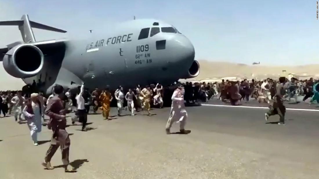 Afghans run alongside a US Air Force transport plane on the runway of the Kabul airport on August 16. &lt;a href=&quot;http://cnn.com/videos/world/2021/08/16/kabul-clinging-to-airplane-taking-off-tarmac-afghanistan-ward-vpx.cnn/video/playlists/afghanistan-falls-to-the-taliban/&quot; target=&quot;_blank&quot;&gt;Video showed&lt;/a&gt; people clinging to the fuselage of the aircraft as it taxied.