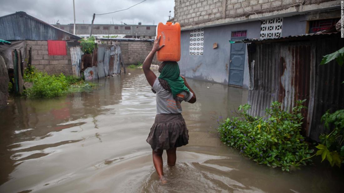 A woman walks in a flooded area of Les Cayes on August 17. &lt;a href=&quot;https://www.cnn.com/2021/08/17/americas/haiti-earthquake-news-tuesday-intl/index.html&quot; target=&quot;_blank&quot;&gt;Tropical Storm Grace&lt;/a&gt; moved across the southern coast of Hispaniola, the island comprising Haiti and the Dominican Republic, just days after the earthquake. The storm &quot;is further disrupting access to water, shelter, and other basic services,&quot; UNICEF said in a statement Tuesday. &quot;Flooding and mudslides are likely to worsen the situation of vulnerable families and further complicate the humanitarian response.&quot;