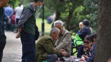 Senior citizens sit together while playing cards in Fuyang, China's Anhui province, on May 12.