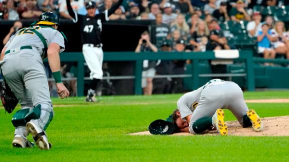 Oakland Athletics pitcher Chris Bassitt, right, holds part of his face after a line drive hit him in Chicago on Tuesday. 