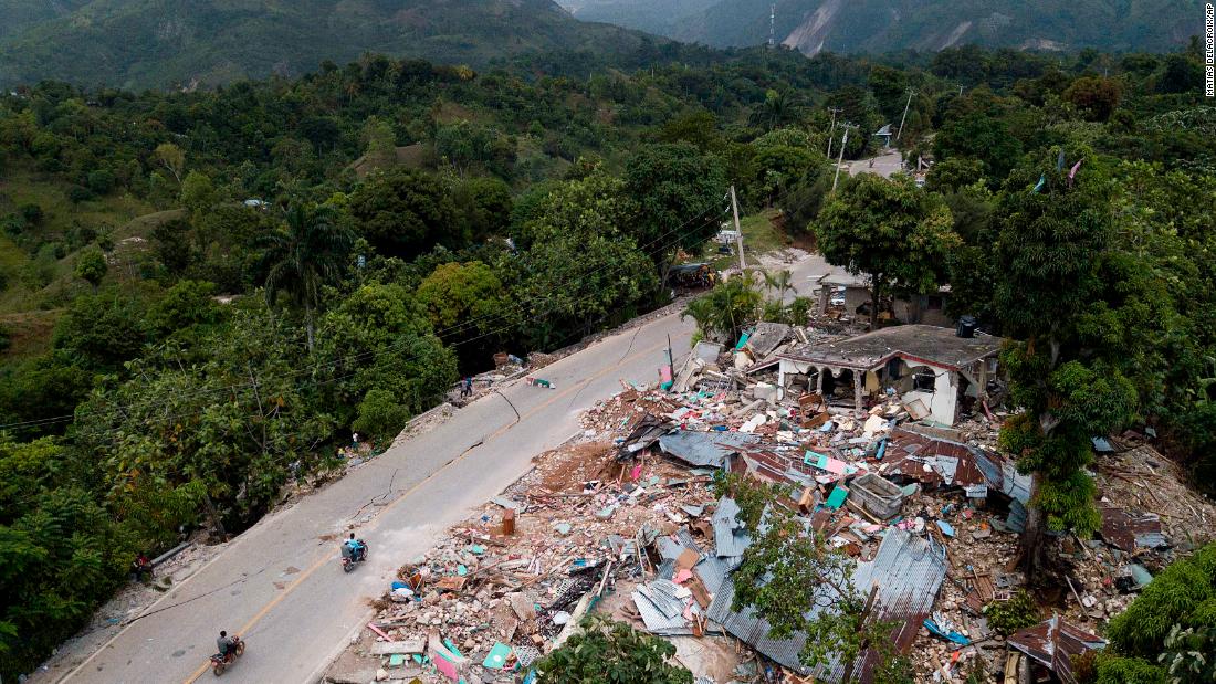 Severely damaged homes are seen along a road in Rampe, Haiti, on August 18.