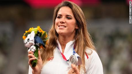 Silver medalist Maria Andrejczyk poses on the podium during the medal ceremony for the women&#39;s javelin throw at the 2020 Summer Olympics.