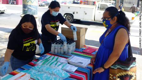 Shirley Pablo Perez and Hilda Lorenzo, members of the Street Level Health Project&#39;s covid-19 outreach and education team, distribute PPE in the Fruitvale neighborhood of Oakland, California on May 2021. They are some of the Mam community members who joined the group in recent years.