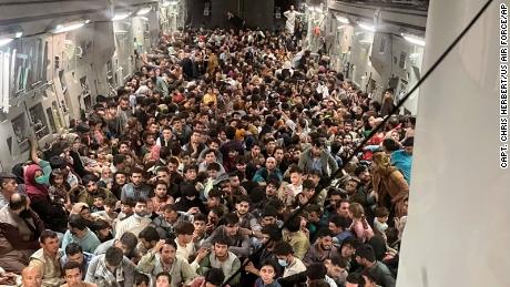 Afghan citizens pack inside a U.S. Air Force C-17 Globemaster III as they are transported from Hamid Karzai International Airport in Afghanistan, Sunday, Aug. 15, 2021.
