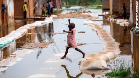A child plays in the floodwaters in Gatumba in Burundi on March 4, 2021.