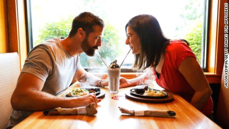 Walker Hayes and wife Laney Beville Hayes splitting a shake at an Applebee&#39;s.