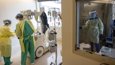 A registered nurse, right, closes the door as staff treat patients in the Covid ward at Ochsner Medical Center in Jefferson, Louisiana, on August 10, 2021.