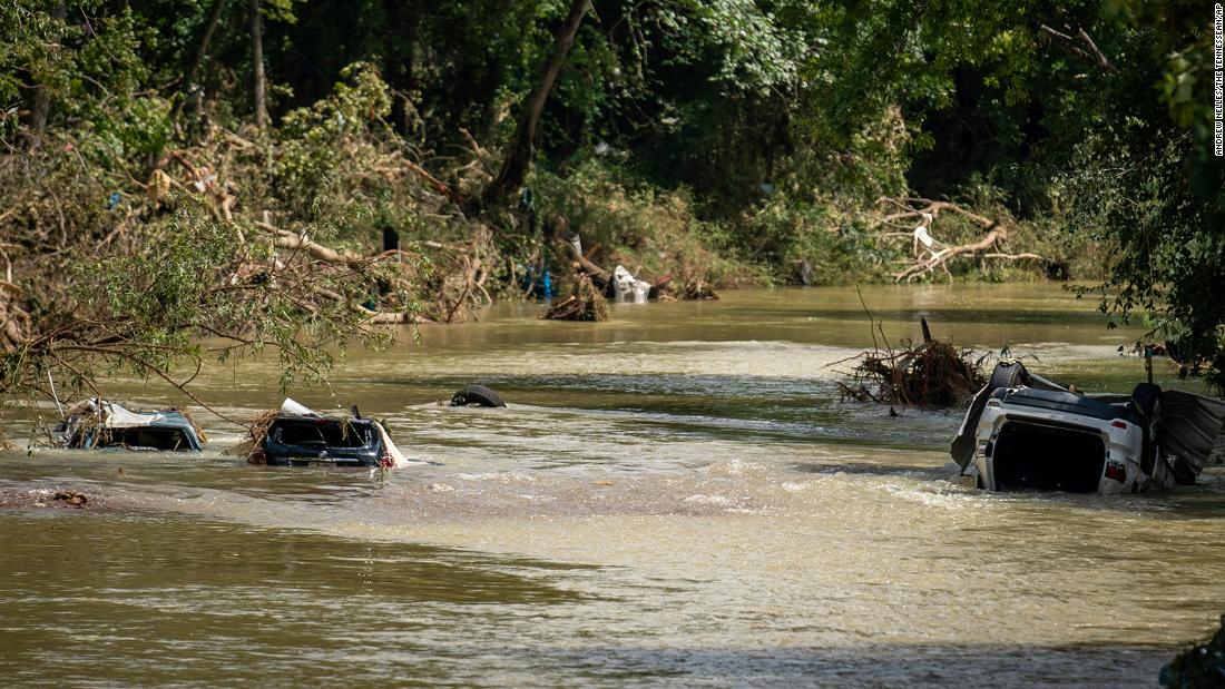 Vehicles are submerged in Trace Creek as a result of severe weather in Waverly, Tennessee.