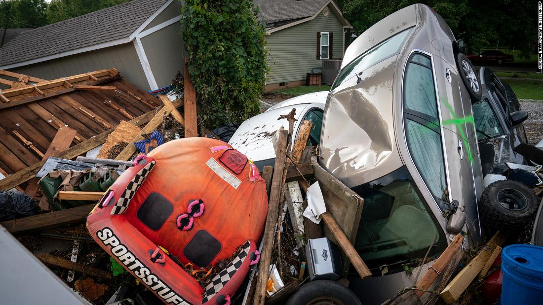 Cars and debris are stacked high along Simpson Avenue in Waverly.