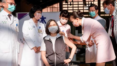 Taiwanese President Tsai Ing-wen, center, receives her first shot of the island&#39;s first domestically developed coronavirus vaccine at the Taiwan University Hospital in Taipei, Taiwan on Monday, August 23.