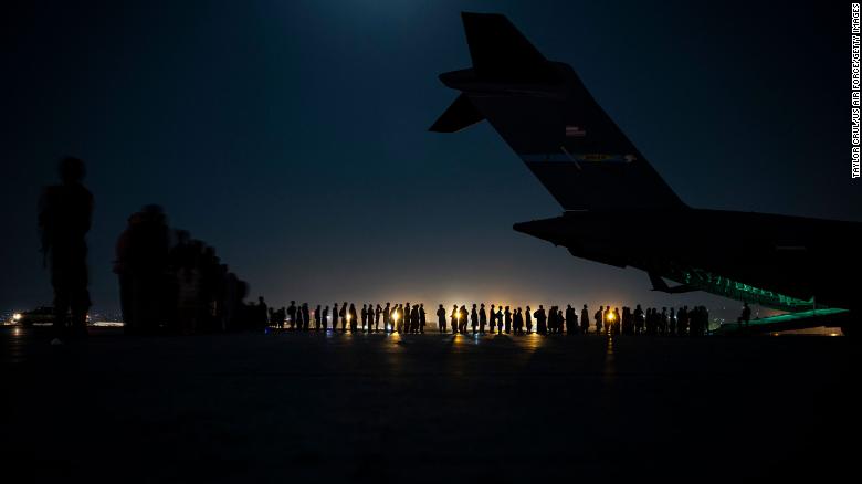 An air crew prepares to load evacuees aboard a C-17 Globemaster III aircraft at Hamid Karzai International Airport on August 21, 2021, in Kabul, Afghanistan. 