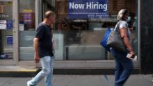 A hiring sign is displayed in a store window in Manhattan on August 19, 2021 in New York City. Despite continued concerns about the Delta variant of the Covid virus, the United States economy continues to grow with the leading economic index jumping 0.9% last month. (Photo by Spencer Platt/Getty Images)