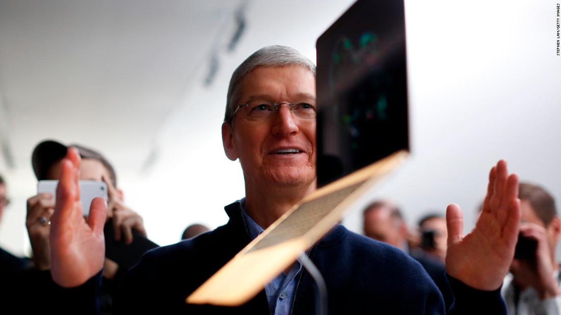 Cook stands in front of a MacBook display after an Apple special event at the Yerba Buena Center for the Arts in San Francisco on March 9, 2015. 