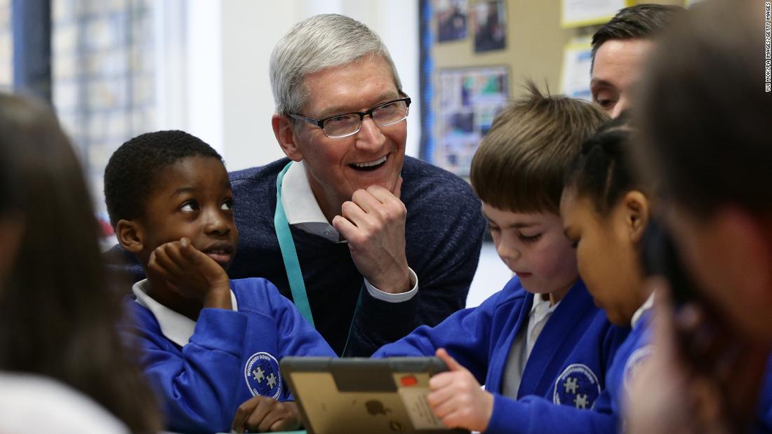 Cook with students at Woodberry Down Community Primary School in Harringay in north London in February 2017. Cook was visiting to see how the school had incorporated Apple&#39;s iPad and related software in its curriculum.