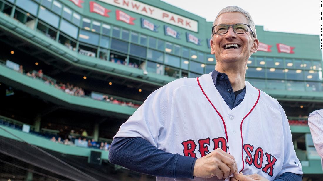 Tim Cook puts on a Boston Red Sox jersey before a game between the Red Sox and the Detroit Tigers at Fenway Park in Boston on June 9, 2017. 