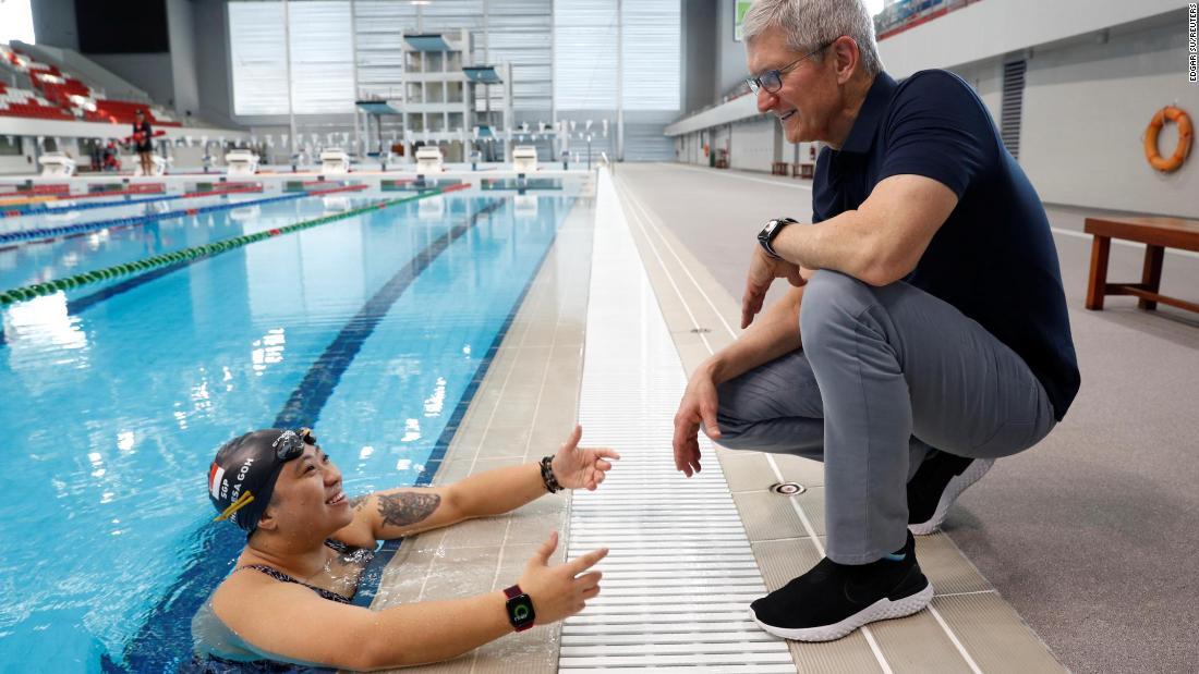 Cook speaks with Singapore Paralympian Theresa Goh about the Apple watch she uses for training at the OCBC Aquatic Centre in Singapore on December 12, 2019. 