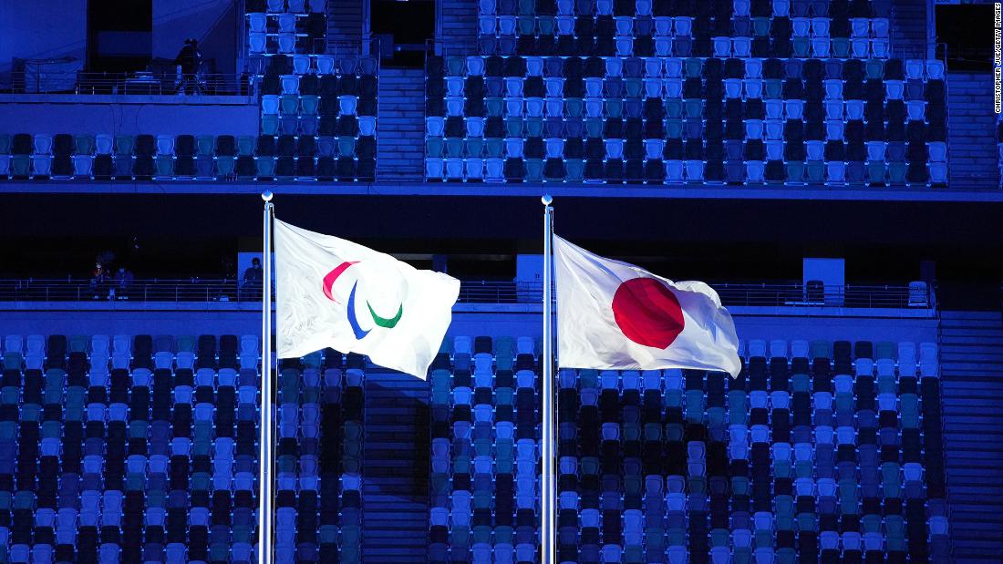 The Paralympic and Japanese flags are flown during the opening ceremony. Most of the stadium&#39;s seats were empty.