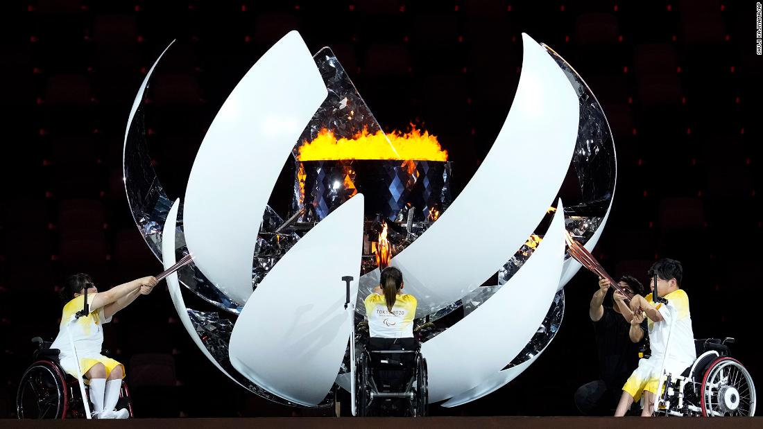 Morisaki, Kamiji and Uchida light the cauldron during the opening ceremony.