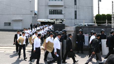 Police officers leave a building connected to the Kudokai crime syndicate in western Japan, on September 15, 2014. 