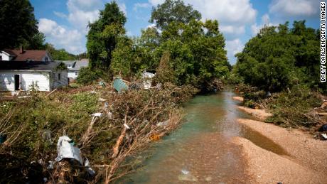 Debris can be seen Monday in the brush around a creek that reached deadly levels over the weekend in Waverly, Tennessee.