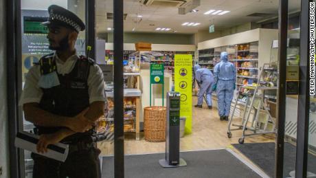 Forensic investigators pictured inside one of the affected supermarkets.