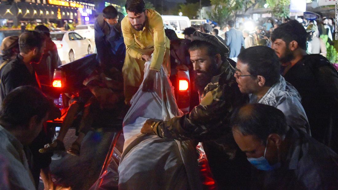 Voluntarios y personal médico descargan cadáveres de una camioneta fuera de un hospital después de la explosión fuera del aeropuerto de Kabul el 26 de agosto.