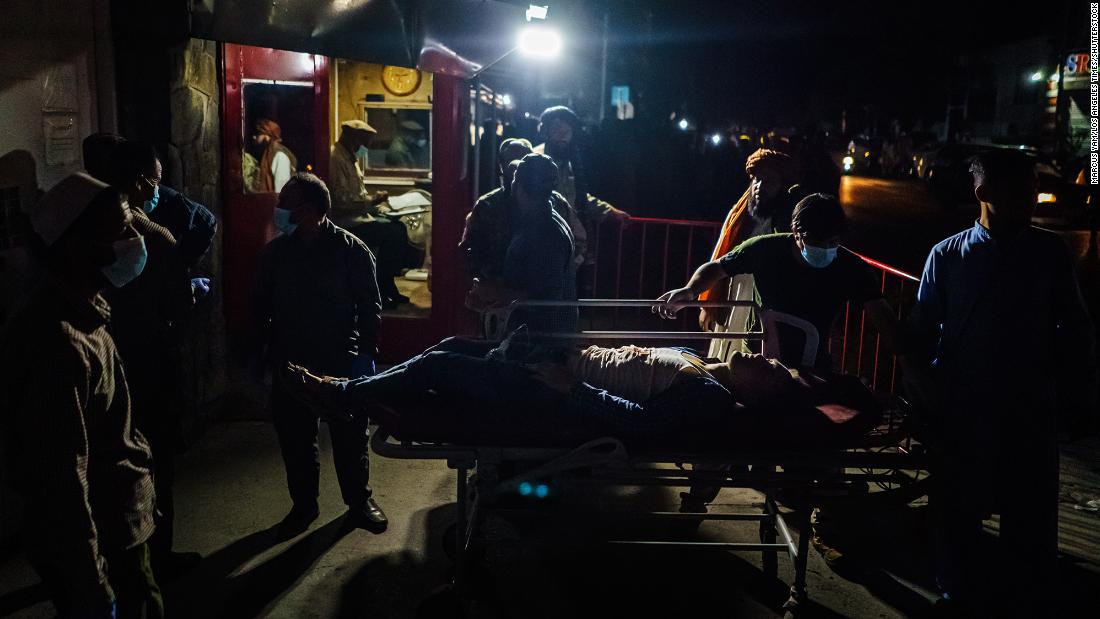 A person is wheeled on a stretcher outside a hospital on Thursday.