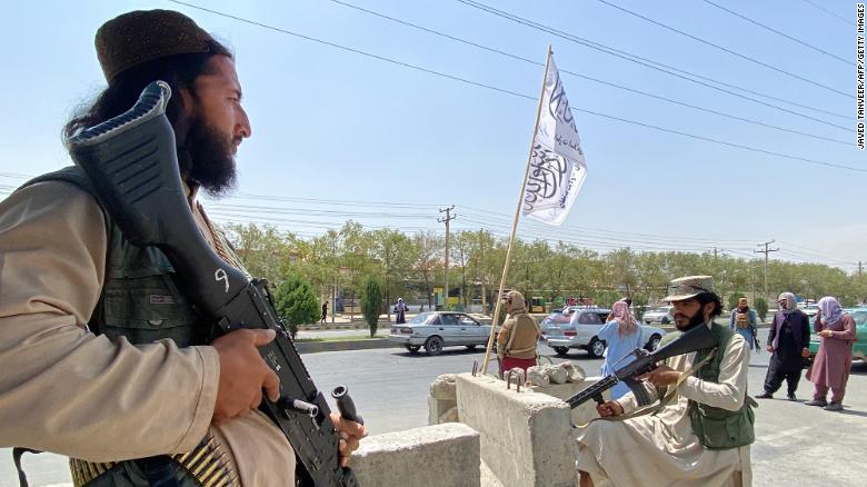 Taliban fighters stand guard at an entrance gate outside the Interior Ministry in Kabul on August 17, 2021.