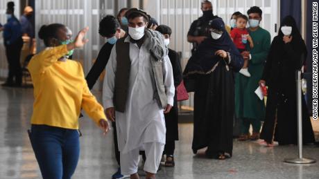 Afghan refugees arrive at Dulles International Airport on Friday in Dulles, Virginia, after being evacuated from Kabul following the Taliban takeover of Afghanistan.