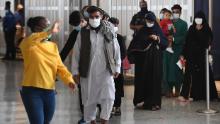 Afghan refugees arrive at Dulles International Airport on August 27, 2021 in Dulles, Virginia, after being evacuated from Kabul following the Taliban takeover of Afghanistan. - The Pentagon said on Friday the ongoing evacuation from Afghanistan faces more threats of attack a day after a suicide bomber and possible associated gunmen killed scores at a Kabul airport gate. (Photo by Olivier DOULIERY / AFP) (Photo by OLIVIER DOULIERY/AFP via Getty Images)