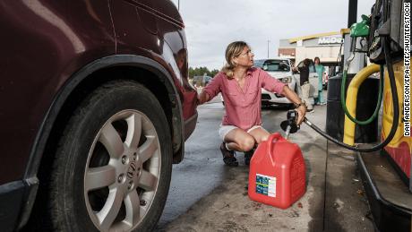 Jennifer Tate fuels up a gas can as she prepares for the arrival of Hurricane Ida in Pass Christian, Mississippi, USA on 27 August 2021. Hurricane Ida is expected to make landfall on the Louisiana coast on the evening of 29 August as a major hurricane.