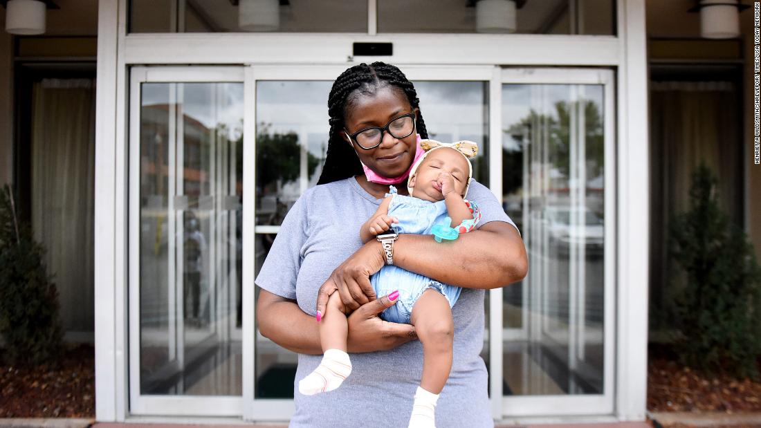 Nikeia Washington from Vacherie, Louisiana, holds her granddaughter, Halia Zenon, at a hotel in downtown Shreveport, Louisiana, where they evacuated to ahead of the storm.