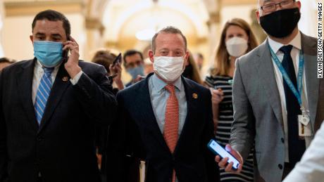 Rep. Josh Gottheimer, center, walks to the office of House Speaker Nancy Pelosi at the Capitol on August 23.