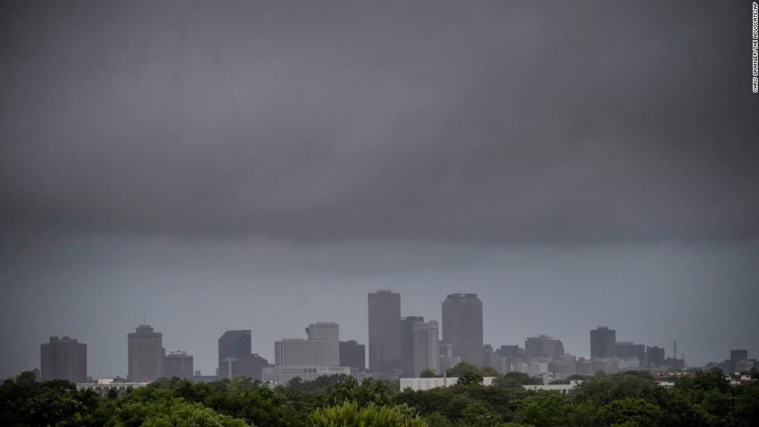 A wall of rain moves over downtown New Orleans on Sunday.