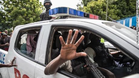 Haitian police transport two alleged suspects to a Port-au-Prince police station on July 8. 

