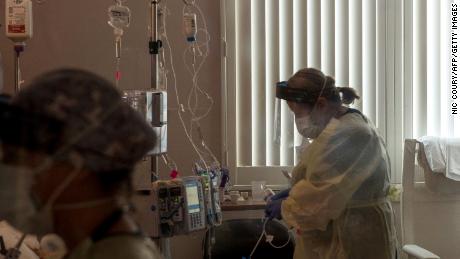 A nurse tends to a Covid-19 patient inside a California ICU.