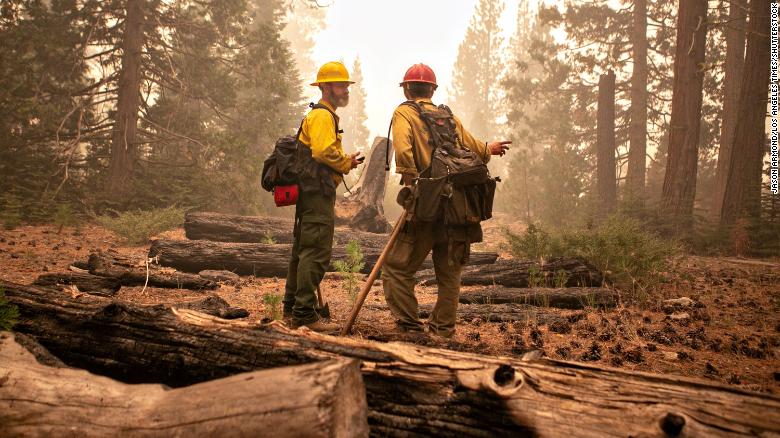 Firefighters with the Eldorado National Forest address the Caldor Fire in Strawberry, California, on Friday, August 27. The raging fire has prompted evacuation orders and warnings in the Lake Tahoe Basin.